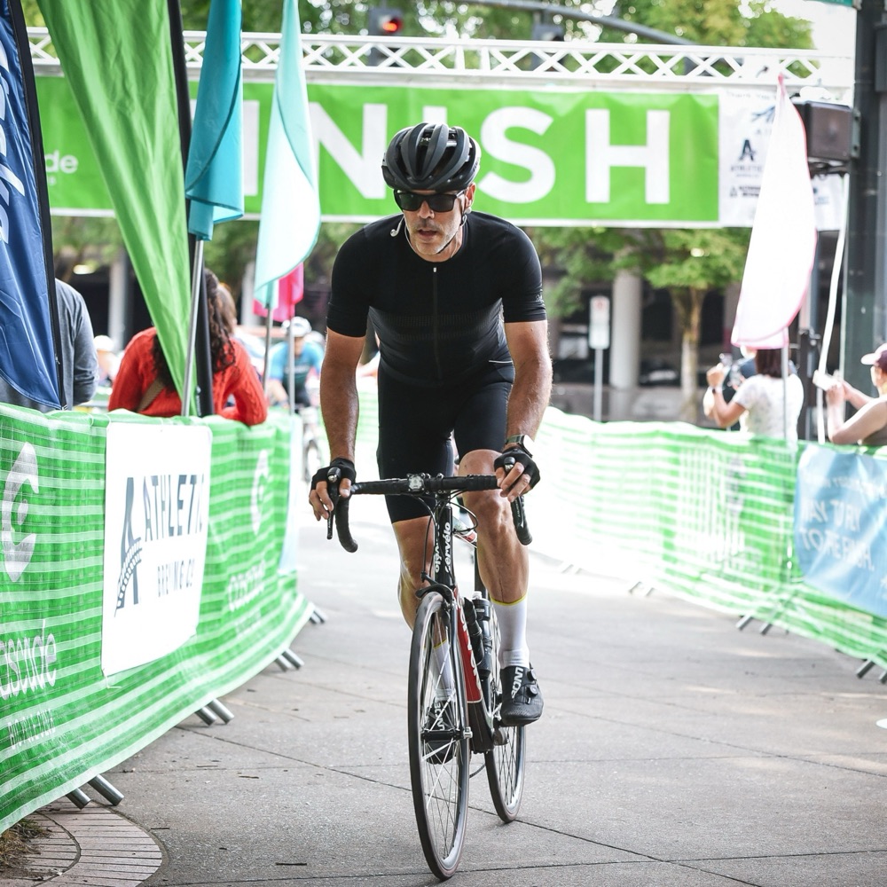 Matthew Westerbeck riding toward the finish line of a long-distance bike ride
